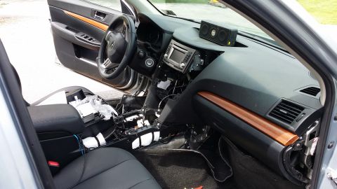2014 Subaru Outback - The interior of a 2014 Subaru Outback shows a disassembled dashboard with wiring and components exposed, suggesting installation or repair…
