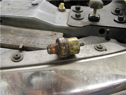 1993 Ford Bronco - Removed oil pressure sensor with visible corrosion on threads and housing.