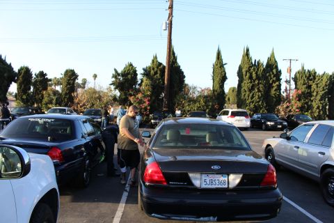 2003 Ford Crown Victoria - black Ford Crown Victoria sedan, California plate 5JBS368, parked among other full-size sedans at an outdoor car-club gathering.
