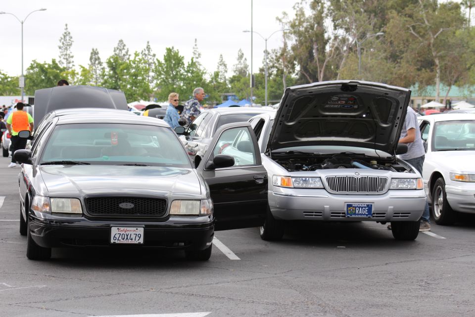 Black Ford 6ZQX479 and silver Mercury RAGE sedan with hood open