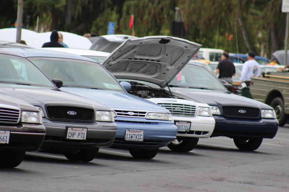 Ford sedans front-on with CHP P71 and 1SMTVIC plates, hood open