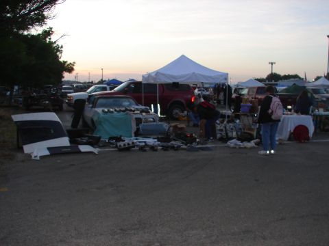 1973 Ford Ranchero - Various car parts are displayed for sale at an outdoor market event.