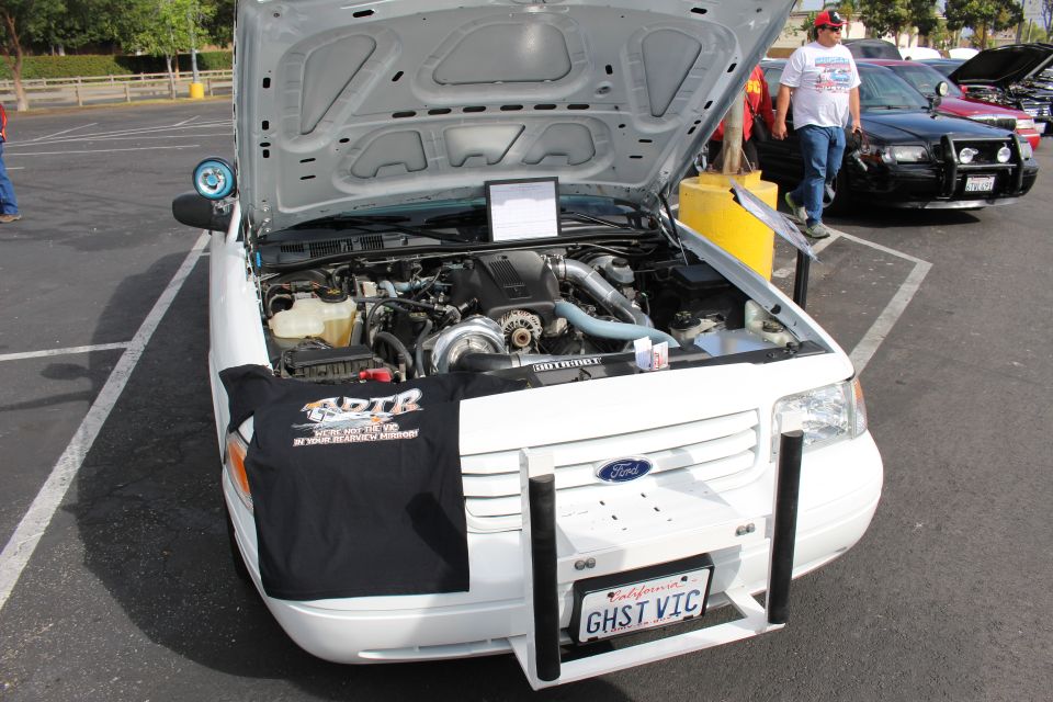 White Ford with raised hood, ADTR banner and GHST VIC plate
