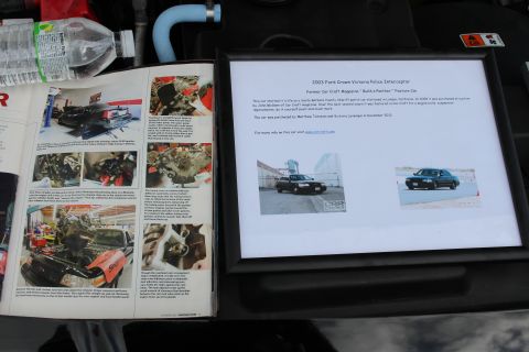 2003 Ford Crown Victoria - Car Craft 'Build a Panther' teardown article shown with a placard for a 2003 Ford Crown Victoria Police Interceptor former feature car; bas…