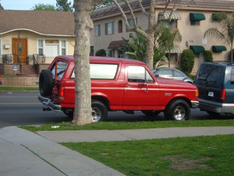 1988 Ford Bronco - Red 1988 Ford Bronco parked on a residential street.