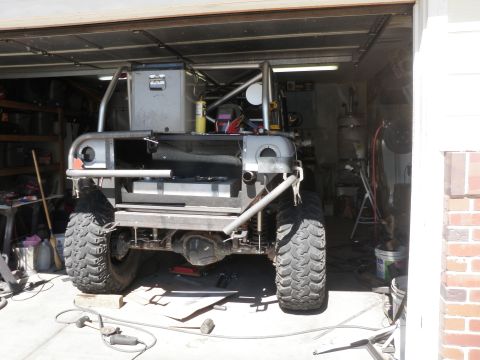 1961 International Scout 800 - Custom off-road vehicle build in progress, showing the rear axle, suspension, and fuel tank.