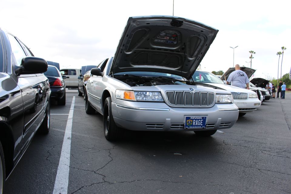 Silver Mercury with open hood and Nevada RAGE plate among show cars