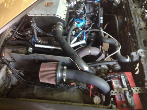 1981 Ford LTD - Passenger side pretty much done. Heat shield protects the air intake. More heat shield on the fuel lines. Crappy battery hold down was the…