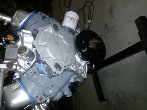 1994 Ford Bronco - Engine assembly with oil filter and pulley, mounted on a stand for service or display.