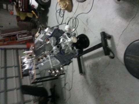 1994 Ford Bronco - Engine assembly on a stand in a garage setting.