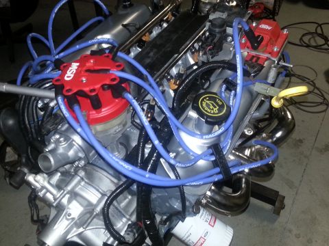 1994 Ford Bronco - Close-up of a Ford V8 engine, MSD ignition parts and exhaust headers.