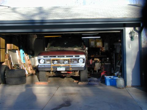 1979 Ford Bronco - This Ford truck, likely from the late 1970s, is parked inside a garage with its front end elevated.
