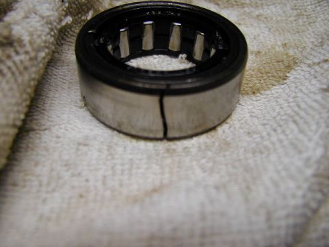 1979 Ford Bronco - A damaged roller bearing rests on a stained cloth, indicating a mechanical failure.