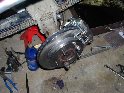 1979 Ford Bronco - A close-up view of a vehicle's rear brake assembly, showing the rotor, caliper, and suspension components.