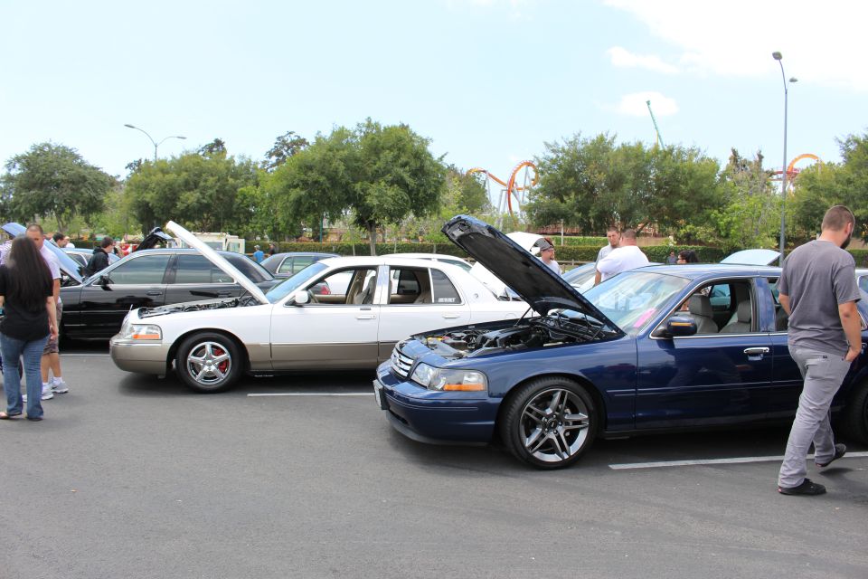 Dark blue Ford Crown Victoria and silver-gold Grand Marquis, hoods up