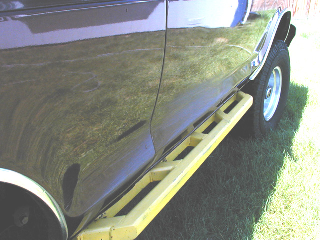 Dark SUV side with yellow step bars