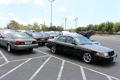 Black Ford sedan front quarter parked beside a gray sedan at car show