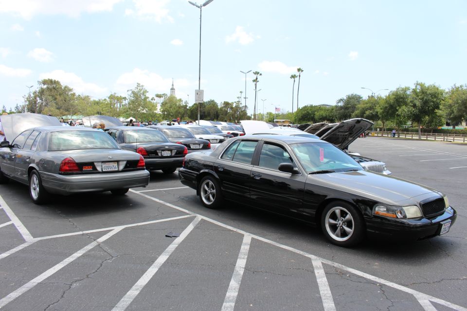 Black Ford sedan front quarter parked beside a gray sedan at car show