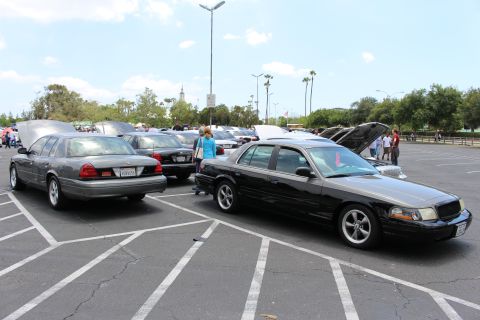 Black Ford sedan parked beside gray sedan at outdoor car meet