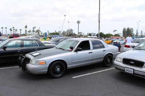 Silver Ford sedan with black steel wheels parked at an angle in a car-meet lot