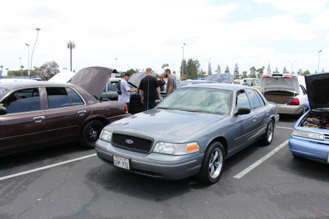 Silver-blue Ford Crown Victoria sedan parked at an outdoor car meet