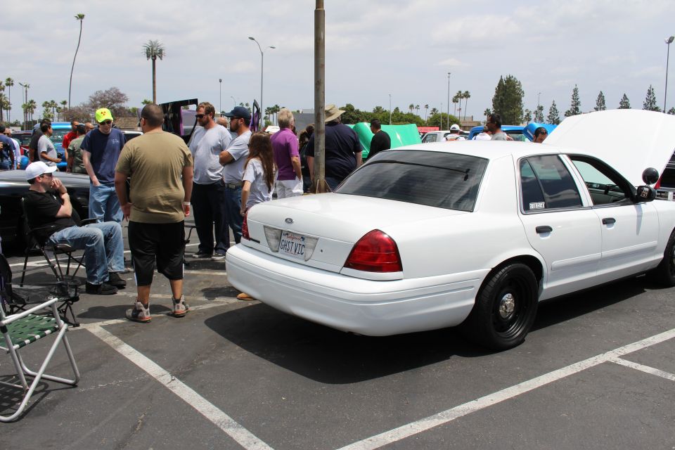 White Ford full-size sedan parked rear-three-quarter at a car show