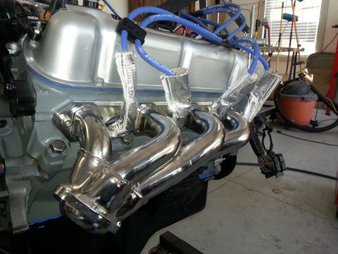 1994 Ford Bronco - Close-up of a vehicle engine's exhaust manifold and spark plug wires.