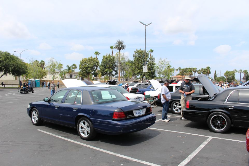 Dark blue full-size sedan parked rear-three-quarter at a car show