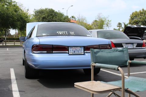 Rear of light blue sedan with 'SWEET VIC' window decal and plate