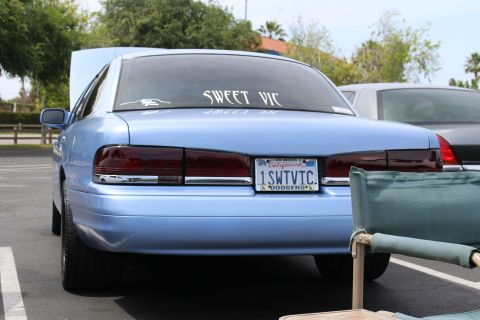 Rear of light blue Ford sedan with "Sweet Vic" rear window decal and California plate 1SWTVTC