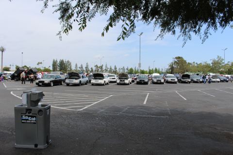 Gray SoCal hand-wash station in foreground with a distant row of show cars
