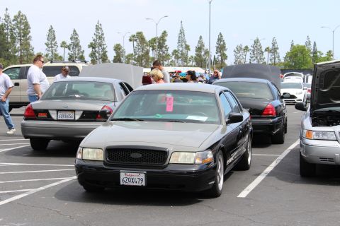 Black full-size sedan with California plate facing camera at car meet