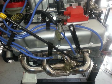 1994 Ford Bronco - Close-up view of an engine assembly, showing spark plug wires and exhaust headers.