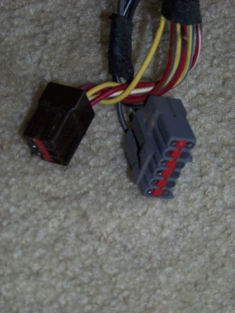 1999 Mercury Grand Marquis - Close-up of two automotive electrical connectors and their wiring harness.
