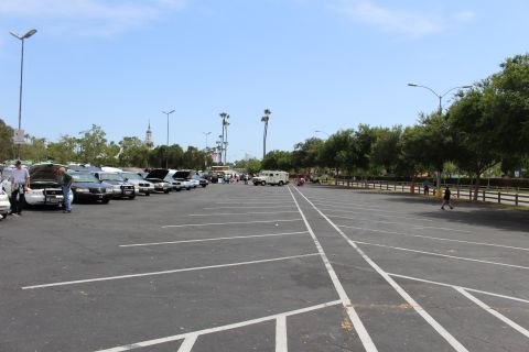 Vast empty parking lot with cars parked along the far left side