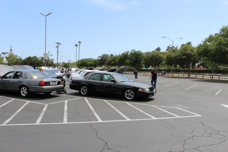 Gray and black full-size sedans parked angled in a wide parking lot
