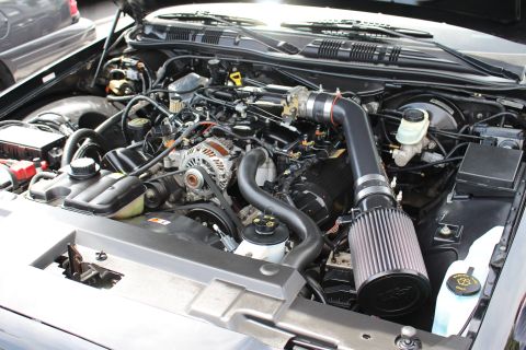 Detailed engine bay with alternator, belt, and black cone air intake