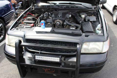 Open engine bay of a Ford Crown Victoria with push bar and light bar