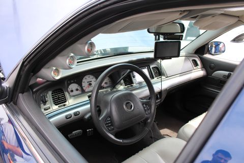 Interior of a sedan with Mercury-badged steering wheel and gauge pod