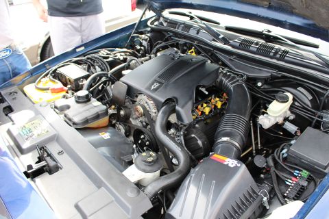 Engine bay of a blue Ford sedan with K&N intake