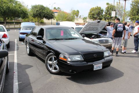 Black Mercury sedan with chrome wheels, plate 4ZDY503, at a meet