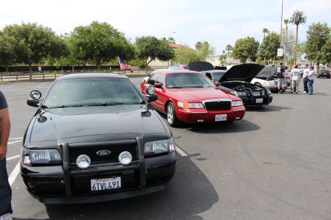 Black Ford Police Interceptor sedan with push bar, plate 6TVI491