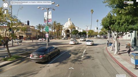 1991 Ford LTD Crown Victoria - A dark sedan is parked on a street in Los Angeles, California, with a domed building in the background.