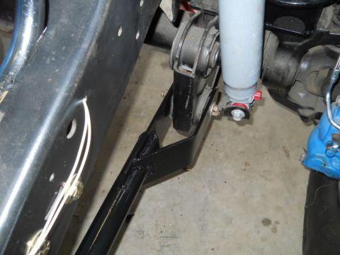1992 Ford Bronco - Detail of a vehicle's suspension system, showing a shock absorber and mounting bracket.