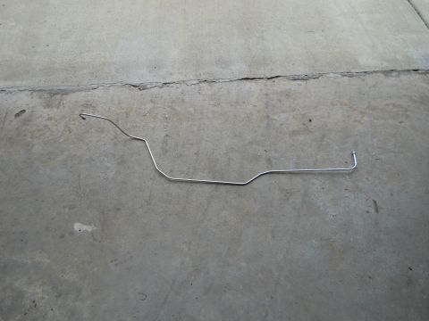 1992 Ford Bronco - Metal fuel line part on concrete. Album claims 1992 Ford Bronco.