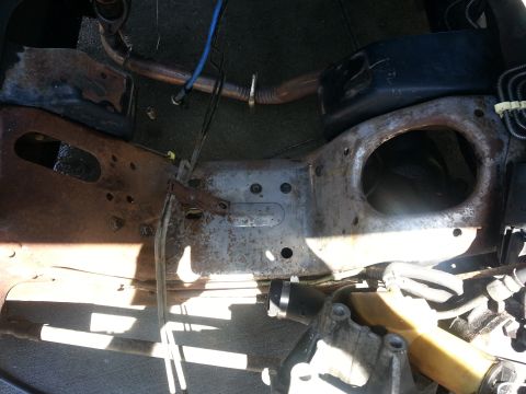 1994 Ford Bronco - Close-up view of a vehicle's engine bay frame, showing hoses and mechanical parts.