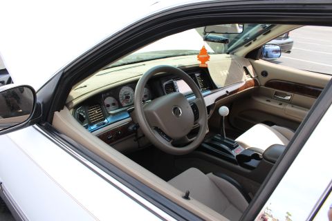 Mercury sedan interior with tan dash, wood trim and a white-knob floor shifter
