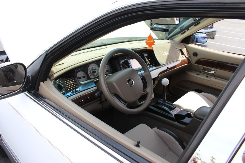 Mercury sedan interior with tan dash, wood trim and a white-knob floor shifter