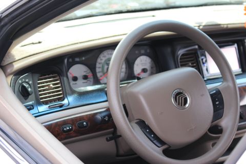 Mercury-badged steering wheel and tan instrument panel with center screen