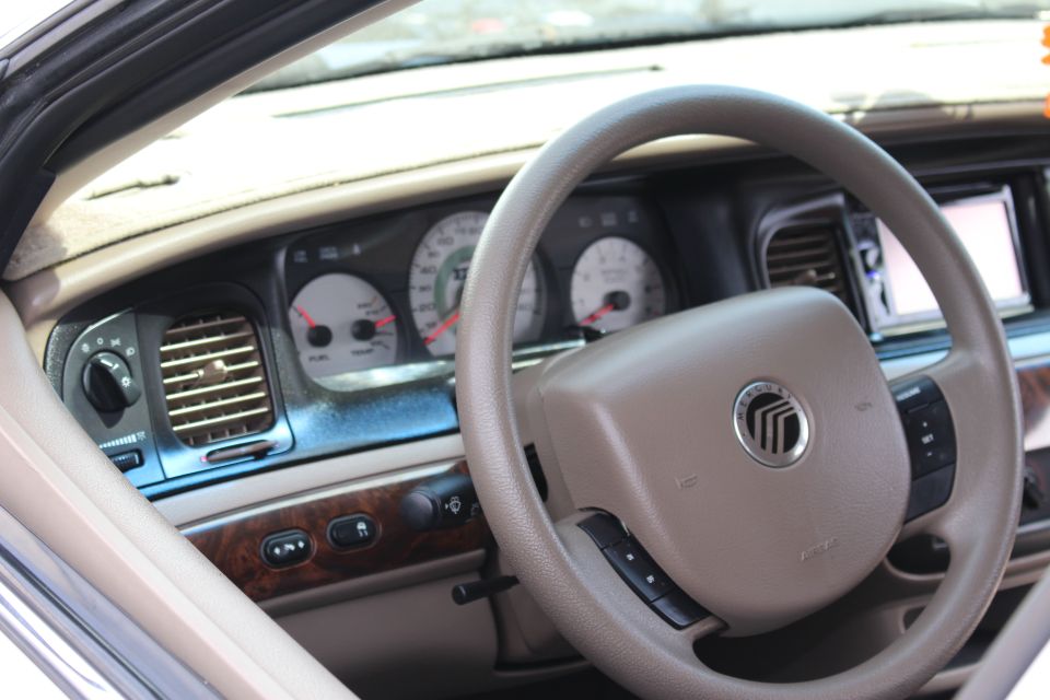 Mercury-badged steering wheel and tan instrument panel with center screen